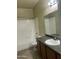 Well-lit bathroom featuring a shower-tub combo and vanity with dark wood cabinets at 1941 S Pierpont Dr # 1014, Mesa, AZ 85206