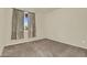 A view of the bedroom with neutral walls, carpet, and a window with drapes at 1941 S Pierpont Dr # 1014, Mesa, AZ 85206