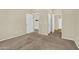 Spacious bedroom with plush carpeting and neutral paint, leading to additional rooms and closet spaces at 1941 S Pierpont Dr # 1014, Mesa, AZ 85206