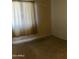 This empty bedroom has neutral carpet and a window with lots of natural light at 1941 S Pierpont Dr # 1014, Mesa, AZ 85206