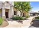 Charming apartment exterior with lush greenery and walkway, leading to covered parking spots at 1941 S Pierpont Dr # 1014, Mesa, AZ 85206