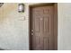 Close-up of a brown front door with the unit number, showcasing a classic and welcoming entrance at 1941 S Pierpont Dr # 1014, Mesa, AZ 85206
