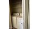 Enclosed laundry room features a side-by-side washer and dryer, as well as wire shelving for storage at 1941 S Pierpont Dr # 1014, Mesa, AZ 85206