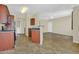 Open-concept living and kitchen area with tiled floor and laundry closet, offering a modern living space at 1941 S Pierpont Dr # 1014, Mesa, AZ 85206