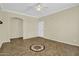 Inviting living room showcasing tile flooring with compass design, neutral walls, and a modern ceiling fan at 1941 S Pierpont Dr # 1014, Mesa, AZ 85206