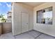 This is a view of the outdoor patio space with a storage closet and window at 1941 S Pierpont Dr # 1014, Mesa, AZ 85206