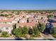 An aerial view showcasing a neighborhood filled with well-maintained homes, tile roofs and mature trees at 1941 W Yellowstone Way, Chandler, AZ 85248