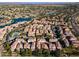 Stunning aerial view of the community with a lake, lush landscaping, and beautiful homes with tile roofs at 1941 W Yellowstone Way, Chandler, AZ 85248