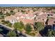 An aerial view showcasing a neighborhood filled with well-maintained homes, lush landscaping, and mature trees at 1941 W Yellowstone Way, Chandler, AZ 85248