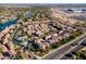 Beautiful aerial view of the community with a lake, lush landscaping, pool, and many homes with tile roofs at 1941 W Yellowstone Way, Chandler, AZ 85248