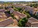 An aerial view showcases a neighborhood filled with well-maintained homes, tile roofs and mature trees at 1941 W Yellowstone Way, Chandler, AZ 85248