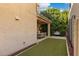 Charming backyard with artificial turf, covered patio, and a cozy seating area surrounded by lush landscaping at 1941 W Yellowstone Way, Chandler, AZ 85248