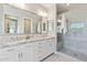 Bathroom featuring double sinks, granite countertops, large mirror, and glass enclosed shower at 1941 W Yellowstone Way, Chandler, AZ 85248