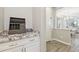 Granite counter with a decorative organizer, table, and an open doorway into the dining room at 1941 W Yellowstone Way, Chandler, AZ 85248