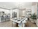 Dining area with view into the kitchen, a stylish table, chandelier, and modern decor at 1941 W Yellowstone Way, Chandler, AZ 85248
