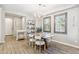 Open dining room featuring a modern chandelier, decorative shelving, and wood-look floors at 1941 W Yellowstone Way, Chandler, AZ 85248