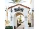 Distinctive entryway to Downtown Ocotillo provides a warm welcome with decorative elements and palm trees at 1941 W Yellowstone Way, Chandler, AZ 85248