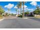 Community entrance with decorative brick, lush landscaping, and mature palm trees adding to curb appeal at 1941 W Yellowstone Way, Chandler, AZ 85248