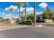 Community entrance with decorative brick, mature palm trees, and manicured landscaping adding to curb appeal at 1941 W Yellowstone Way, Chandler, AZ 85248