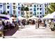 Vibrant Ocotillo Farmers Market with tents and crowds against a backdrop of sunny apartment buildings at 1941 W Yellowstone Way, Chandler, AZ 85248