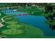 Scenic aerial view of Ocotillo Golf Course featuring lush green fairways, a tranquil lake, and beautiful landscaping at 1941 W Yellowstone Way, Chandler, AZ 85248