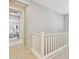 Hallway with white railings, carpeted floors, and a view of a bedroom at 1941 W Yellowstone Way, Chandler, AZ 85248