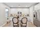 Bright kitchen with granite island, modern stainless steel appliances, white cabinetry and wood flooring at 1941 W Yellowstone Way, Chandler, AZ 85248