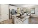 Island kitchen with stainless steel appliances, granite countertops and open to the dining area at 1941 W Yellowstone Way, Chandler, AZ 85248