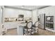 Bright kitchen with white cabinetry, stainless steel appliances, and granite countertops with seating at 1941 W Yellowstone Way, Chandler, AZ 85248