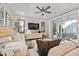 Bright living room with neutral color palette, ceiling fan, sliding glass doors to patio, and comfortable furniture at 1941 W Yellowstone Way, Chandler, AZ 85248