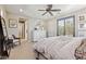 Calm main bedroom with neutral walls, carpet flooring, ceiling fan, and hallway access for convenience at 1941 W Yellowstone Way, Chandler, AZ 85248