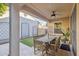 A cozy covered patio with a wooden dining set and a ceiling fan at 1941 W Yellowstone Way, Chandler, AZ 85248