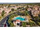 Aerial view showcases community pool with lounge area and nearby neighborhood lake at 1941 W Yellowstone Way, Chandler, AZ 85248