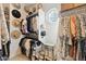 Bright walk-in closet with white shelving, hanging racks, round window, and mirrored vanity at 1941 W Yellowstone Way, Chandler, AZ 85248