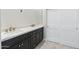Bathroom features a double vanity with marble countertop and dark wood cabinets at 19550 N Grayhawk Dr # 1144, Scottsdale, AZ 85255