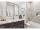 Stylish bathroom features a modern vanity, tile backsplash, and a shower/tub combo at 19550 N Grayhawk Dr # 1144, Scottsdale, AZ 85255