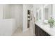Modern bathroom with walk-in shower, custom cabinets, and backlit mirrors at 19550 N Grayhawk Dr # 1144, Scottsdale, AZ 85255