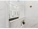 Bright bathroom featuring a walk-in shower with marble tile and a double vanity with backlit mirrors at 19550 N Grayhawk Dr # 1144, Scottsdale, AZ 85255