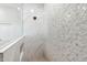 Sleek walk-in shower with stylish geometric tile, built-in niche, and marble accents at 19550 N Grayhawk Dr # 1144, Scottsdale, AZ 85255