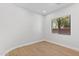 Well-lit bedroom features hardwood floors and a bright window at 19550 N Grayhawk Dr # 1144, Scottsdale, AZ 85255