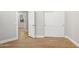 Hardwood floors in a bedroom with an open door leading to the hallway at 19550 N Grayhawk Dr # 1144, Scottsdale, AZ 85255