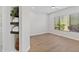 A bright bedroom with hardwood floors, a ceiling fan, and decorative shelving at 19550 N Grayhawk Dr # 1144, Scottsdale, AZ 85255