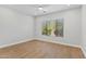 Bedroom with hardwood floors, a ceiling fan, and a bright window at 19550 N Grayhawk Dr # 1144, Scottsdale, AZ 85255