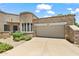 Charming home featuring a barrel tile roof, stone accents, a two-car garage, and desert landscaping at 19550 N Grayhawk Dr # 1144, Scottsdale, AZ 85255
