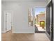 Bright entryway with stylish wood floors, a modern front door, and views of the desert landscape at 19550 N Grayhawk Dr # 1144, Scottsdale, AZ 85255