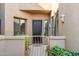 Charming front entryway featuring a decorative metal gate, neat landscaping, and a modern solid door at 19550 N Grayhawk Dr # 1144, Scottsdale, AZ 85255