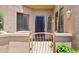 Inviting front entrance features a sleek black door, desert landscaping, and a secure courtyard at 19550 N Grayhawk Dr # 1144, Scottsdale, AZ 85255