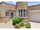 Close up of the front of the house featuring desert landscaping and a two-car garage at 19550 N Grayhawk Dr # 1144, Scottsdale, AZ 85255