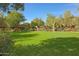 Lush green lawn offers a serene setting with mature trees and colorful flowering bushes at 19550 N Grayhawk Dr # 1144, Scottsdale, AZ 85255