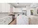 Bright, modern kitchen features white cabinets, a large island, and stainless steel appliances at 19550 N Grayhawk Dr # 1144, Scottsdale, AZ 85255